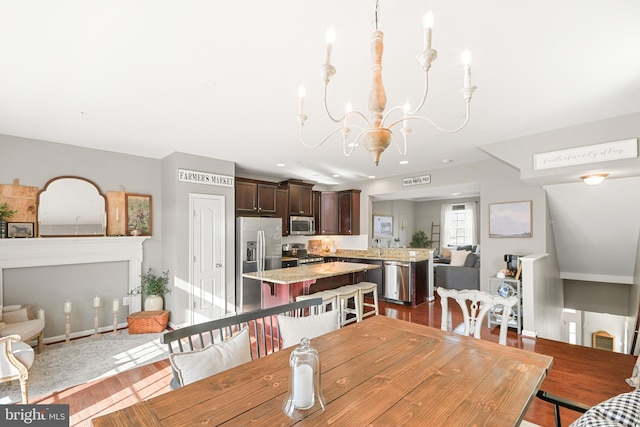 dining space featuring an inviting chandelier and wood-type flooring