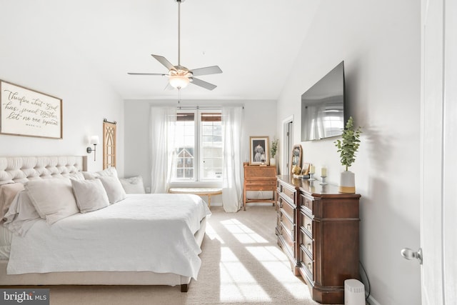 carpeted bedroom with vaulted ceiling and ceiling fan