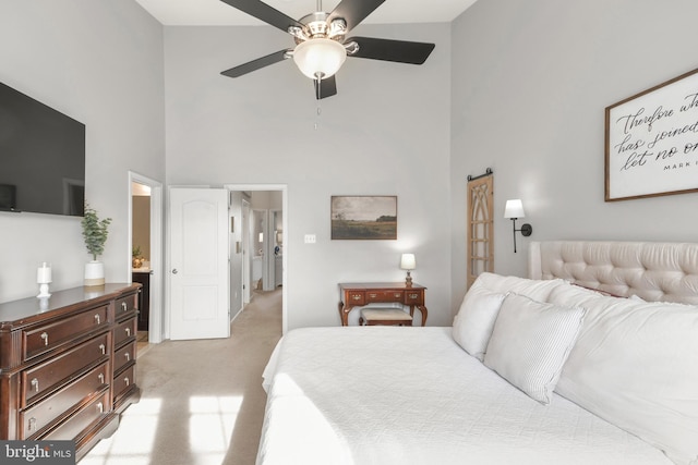 carpeted bedroom featuring a towering ceiling and ceiling fan