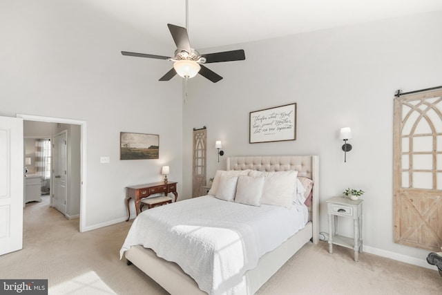 carpeted bedroom featuring ceiling fan and a high ceiling