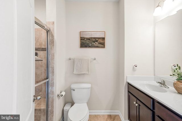 bathroom with vanity, toilet, and a shower with shower door