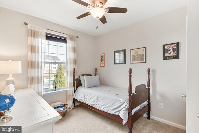 bedroom with light carpet and ceiling fan