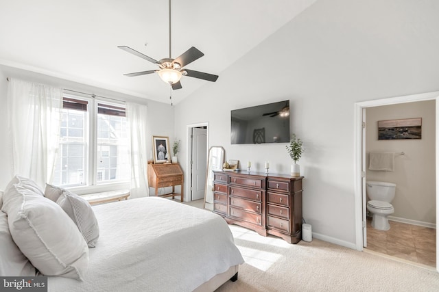 carpeted bedroom with vaulted ceiling, connected bathroom, and ceiling fan