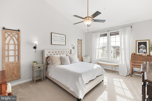 bedroom featuring ceiling fan, lofted ceiling, a barn door, and light carpet