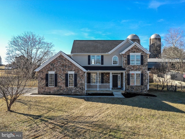 front facade with a porch and a front lawn