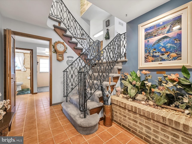 stairway with tile patterned flooring