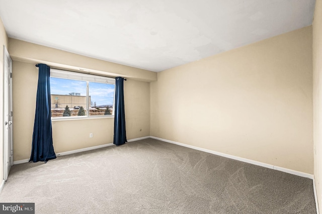 unfurnished room featuring light carpet