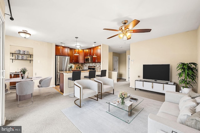 living room with ceiling fan and light colored carpet