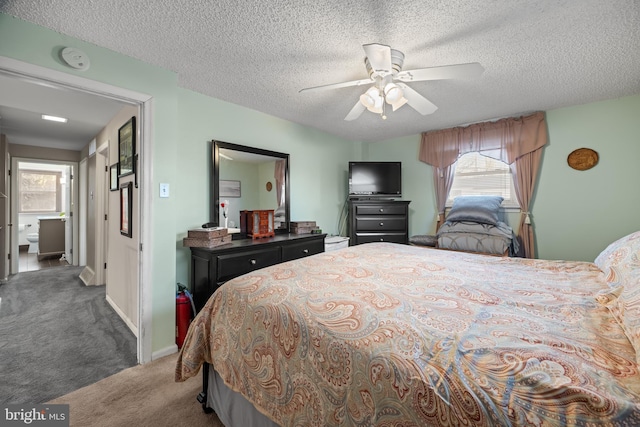 bedroom featuring ceiling fan, carpet floors, and a textured ceiling