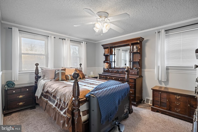 carpeted bedroom with crown molding, ceiling fan, and a textured ceiling