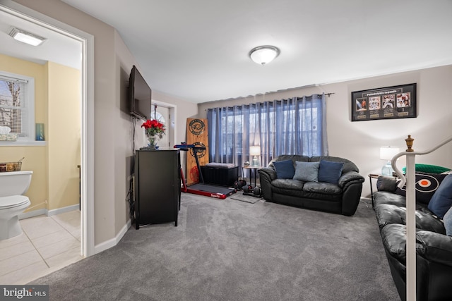 tiled living room featuring a healthy amount of sunlight