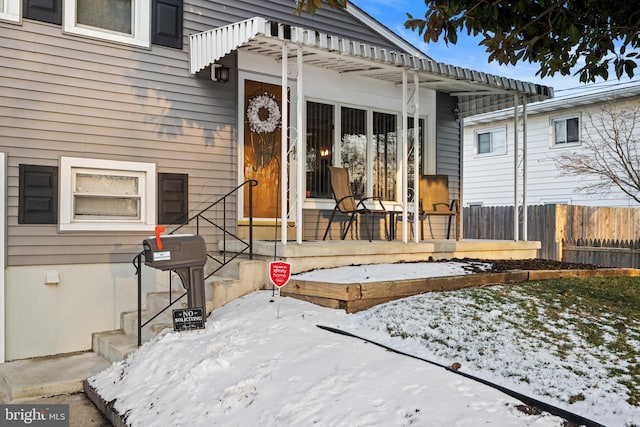 view of snow covered property entrance