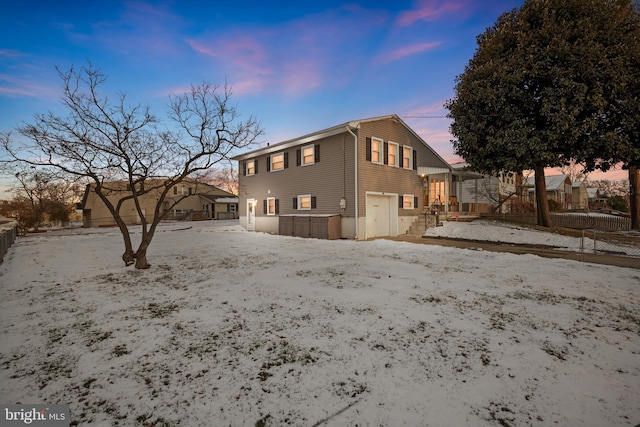 property exterior at dusk featuring a garage