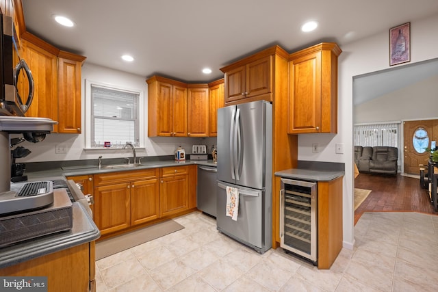 kitchen featuring wine cooler, sink, and stainless steel appliances