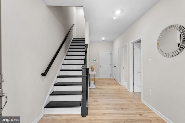 staircase with wood-type flooring