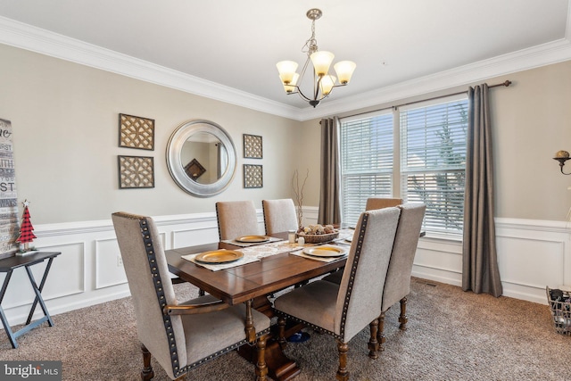 dining room with a notable chandelier, crown molding, and carpet floors