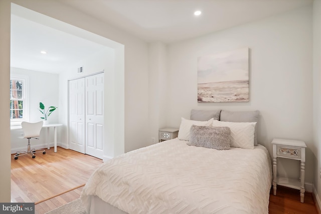 bedroom featuring hardwood / wood-style floors and a closet