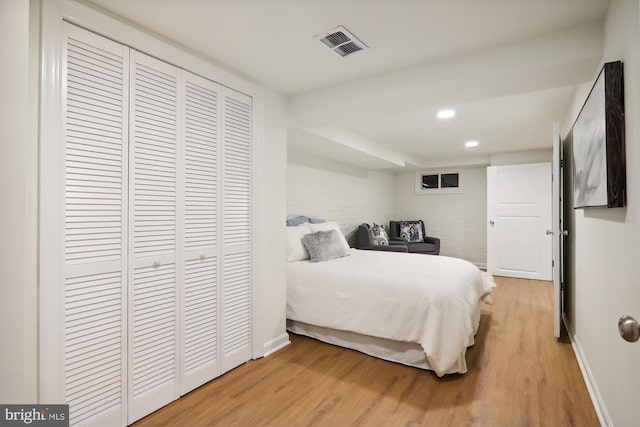 bedroom featuring a closet and light hardwood / wood-style flooring