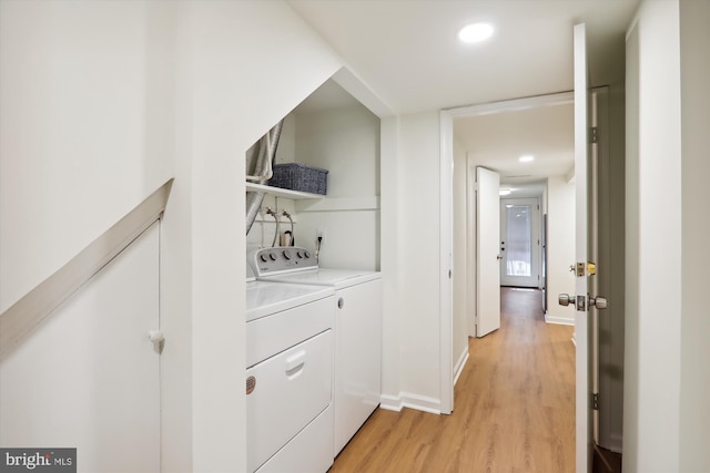 washroom with washer and dryer and light hardwood / wood-style floors