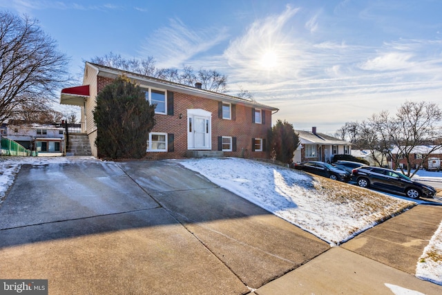 bi-level home featuring brick siding