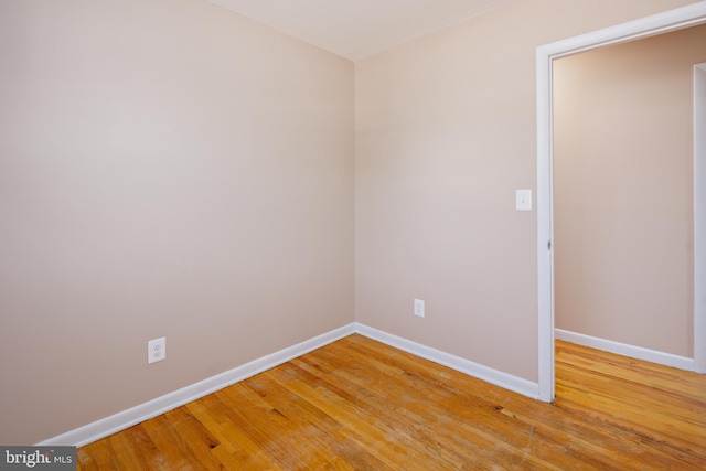 empty room featuring baseboards and light wood-style floors