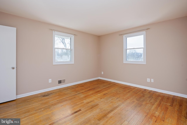 empty room with visible vents, baseboards, and light wood-style flooring