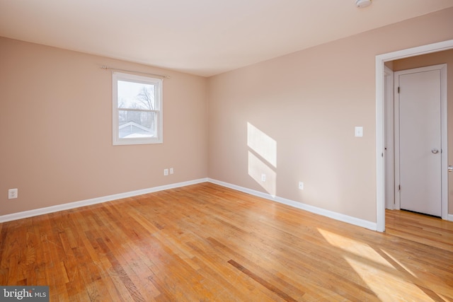 empty room with light wood-style floors and baseboards