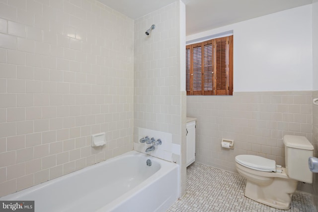 full bathroom featuring vanity, bathtub / shower combination, tile walls, toilet, and tile patterned floors