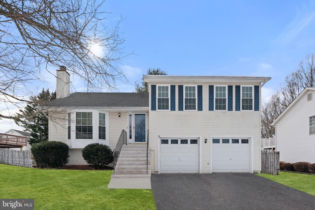 view of front of home featuring a garage and a front lawn