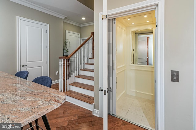 stairway with recessed lighting, crown molding, baseboards, and wood finished floors