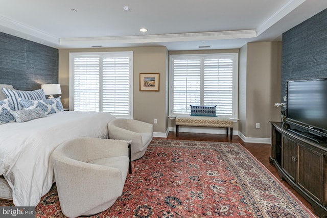 bedroom with wallpapered walls, an accent wall, dark wood-type flooring, and crown molding