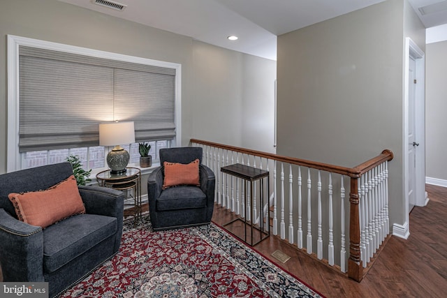 sitting room with visible vents, baseboards, wood finished floors, and recessed lighting