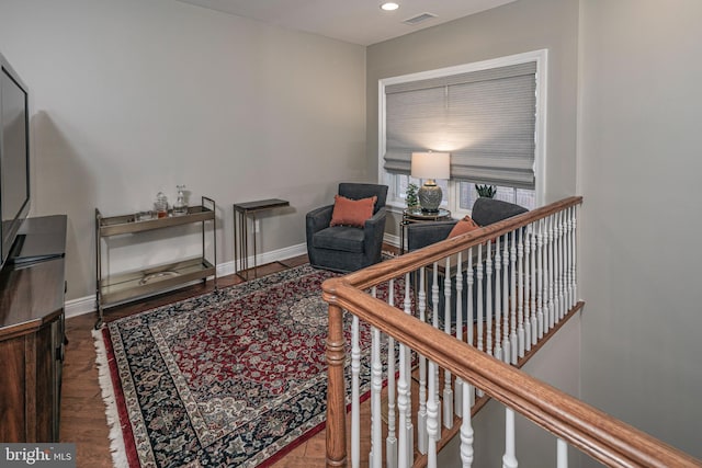 sitting room with recessed lighting, visible vents, an upstairs landing, wood finished floors, and baseboards