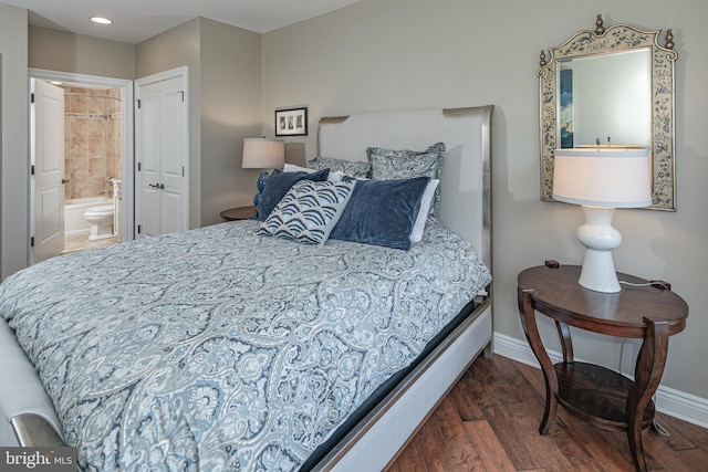 bedroom featuring recessed lighting, dark wood-style flooring, baseboards, and ensuite bathroom