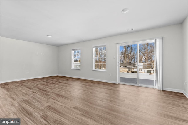 spare room featuring light hardwood / wood-style flooring