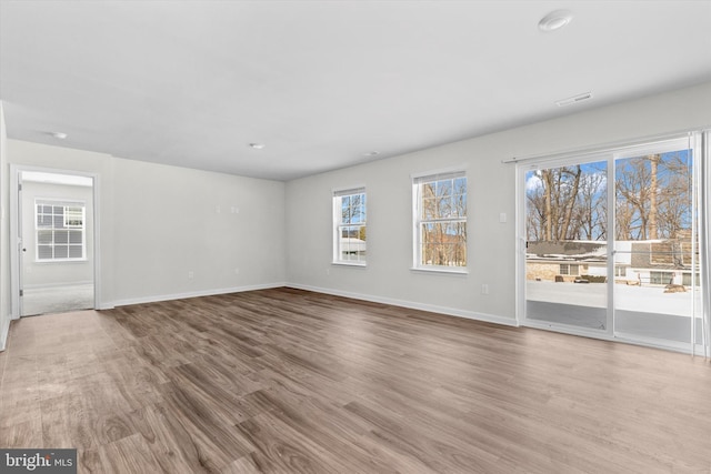 unfurnished room with hardwood / wood-style floors