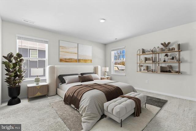 carpeted bedroom featuring multiple windows