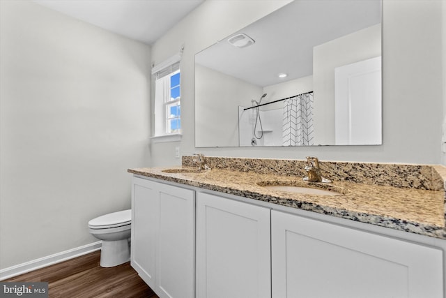 bathroom with vanity, hardwood / wood-style floors, toilet, and walk in shower