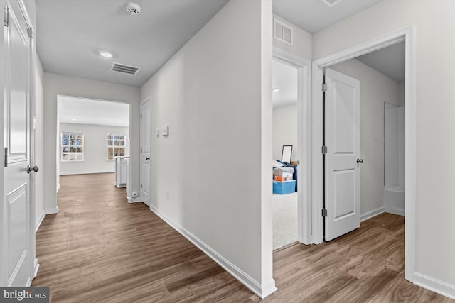 hallway with light wood-type flooring