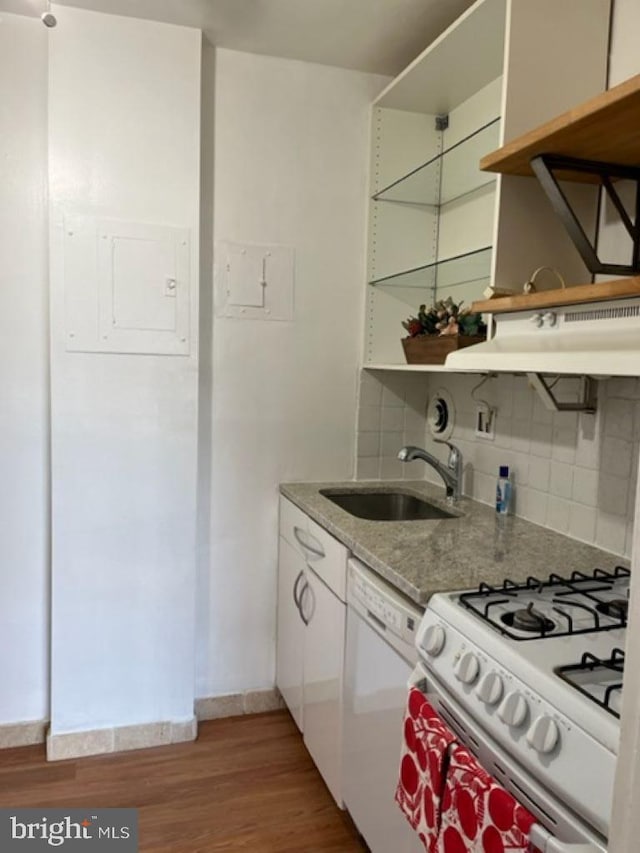 kitchen featuring white appliances, hardwood / wood-style floors, sink, backsplash, and white cabinets