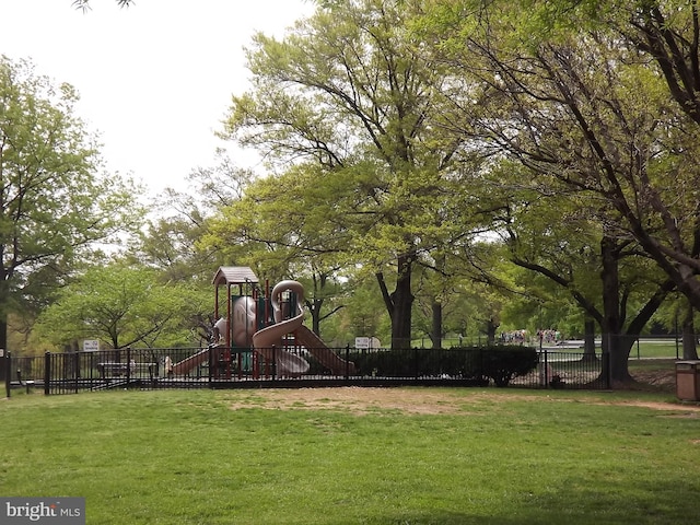 view of property's community with a playground and a lawn