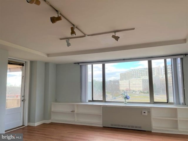 empty room with radiator and light hardwood / wood-style flooring