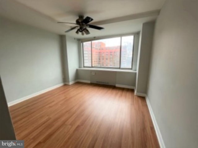 empty room featuring ceiling fan and light wood-type flooring