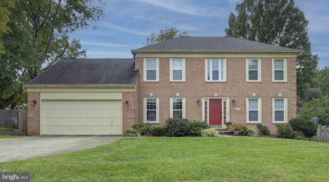 colonial-style house with a garage and a front lawn