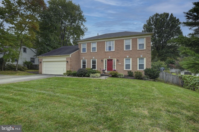 colonial inspired home with a garage and a front lawn