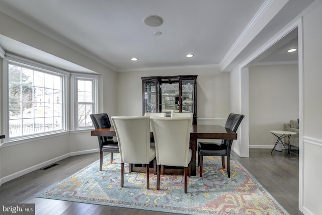 dining room featuring hardwood / wood-style flooring and ornamental molding