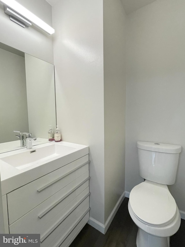 bathroom featuring vanity, toilet, and wood-type flooring