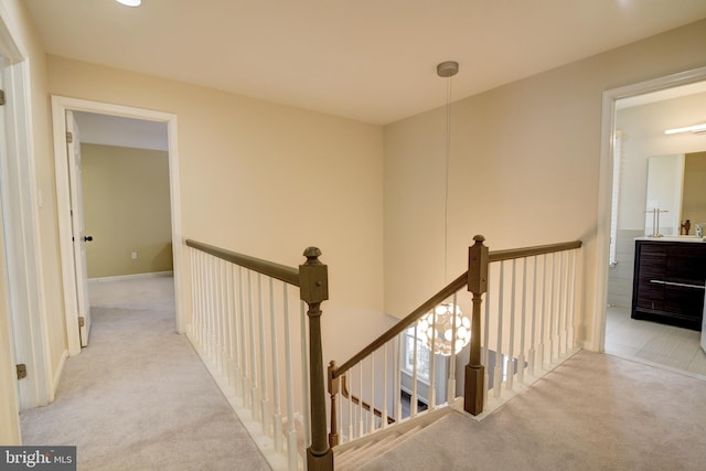 hall featuring light colored carpet