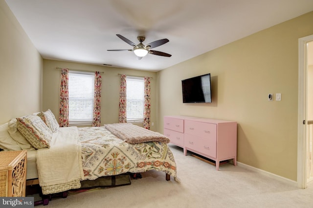 bedroom featuring light colored carpet and ceiling fan