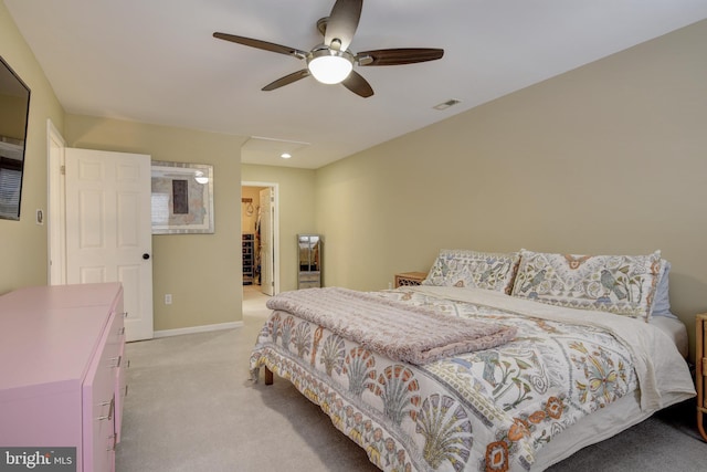 carpeted bedroom with ceiling fan, a spacious closet, and a closet